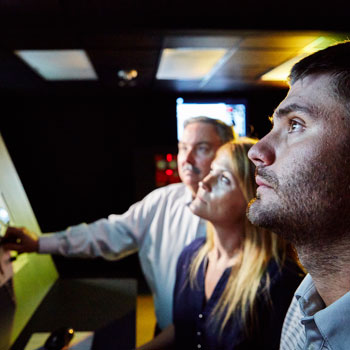 Superior Energy Service engineers looking up at a screen