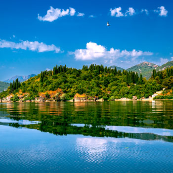 A beautiful lake reflecting rolling green hills